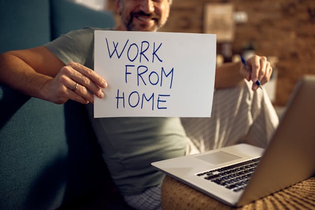 hybrid-work-policy-worker-holding-a-paper-work-from-home